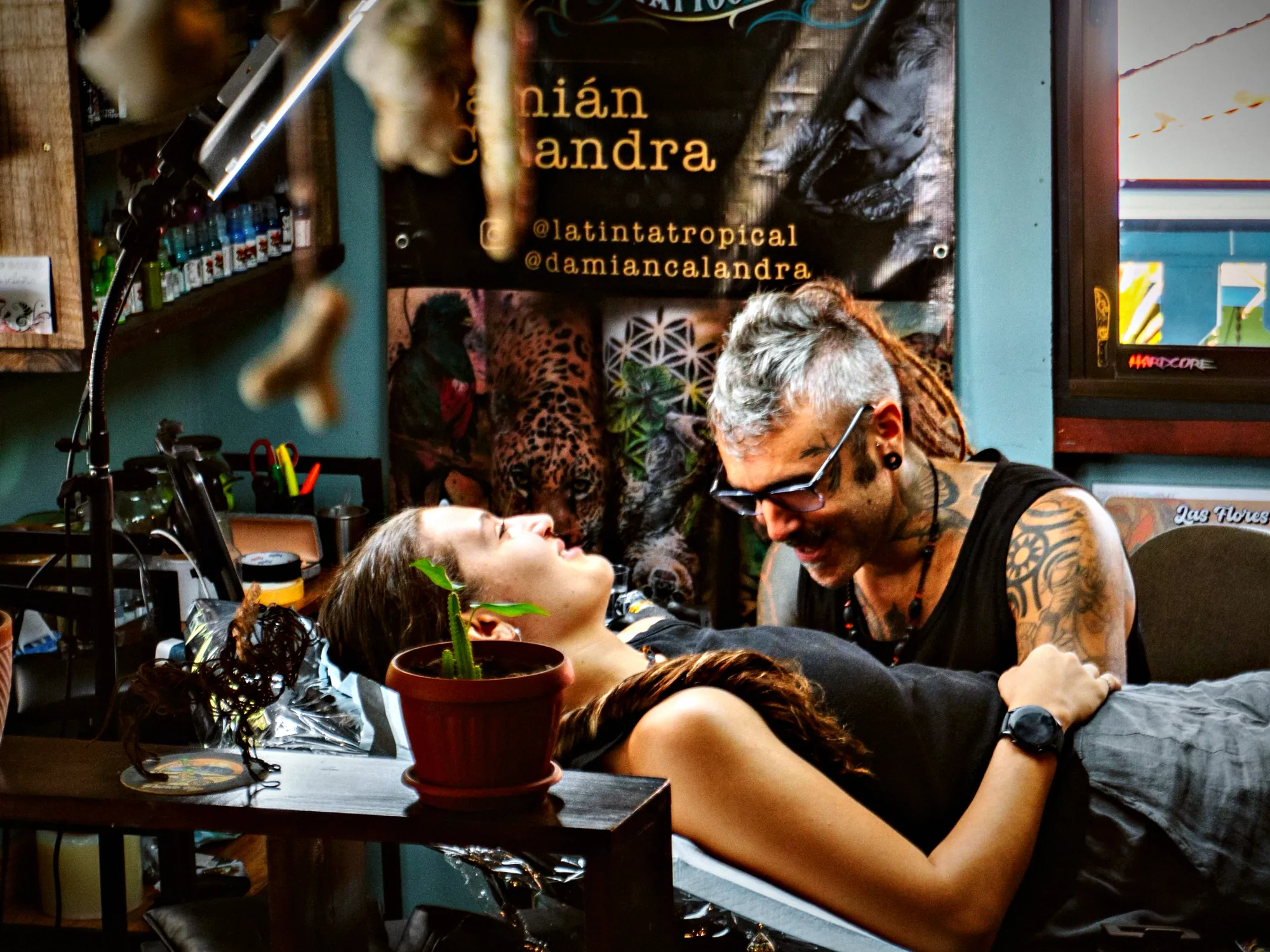 Damián with a client under his name banner