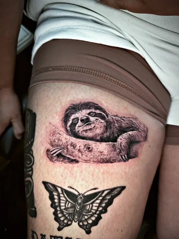 Sloth and butterfly tattoo by Damián Calandra