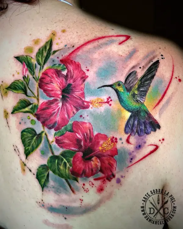 Hibiscus flowers and hummingbird on the shoulder blade tattoo by Damián Calandra