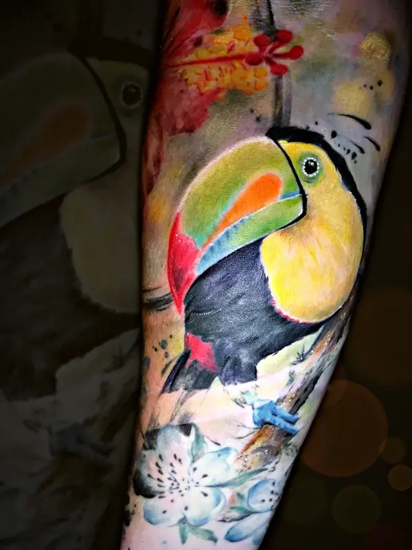 Toucan with flowers tattoo by Damián Calandra