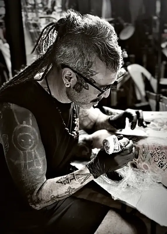 Damián drawing a design, black and white