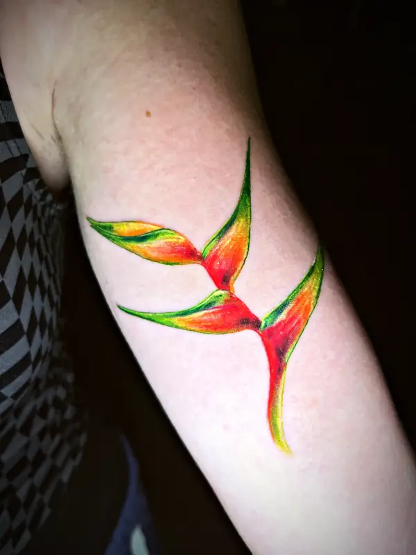 Heliconia flower in color tattoo by Damián Calandra
