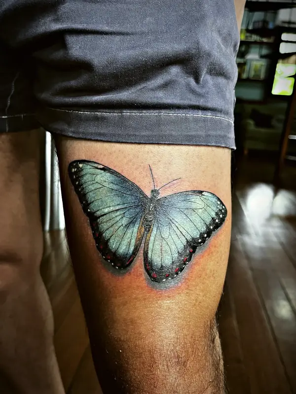 Blue morpho butterfly tattoo by Damián Calandra